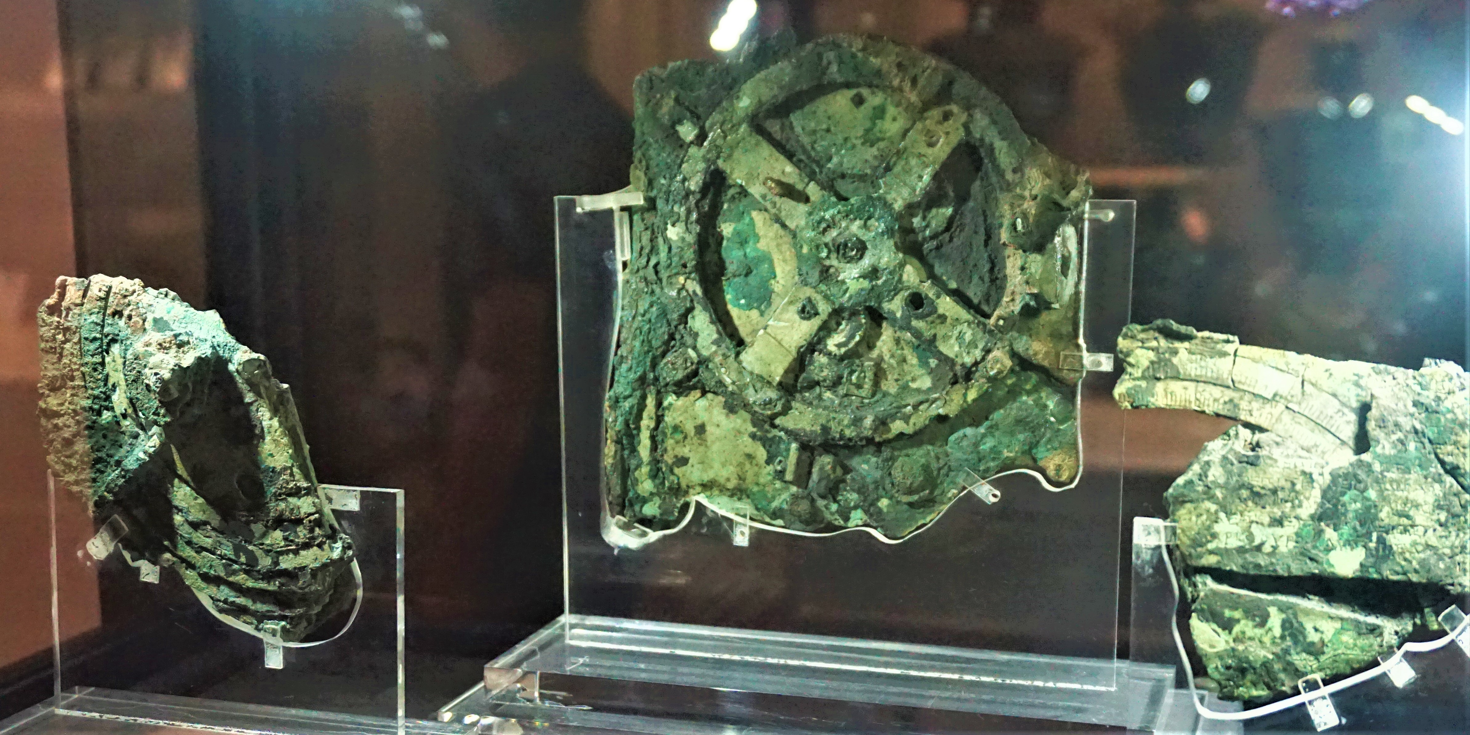 Antikythera mechanism fragments in a display case at the National Archaeological Museum, Athens.
