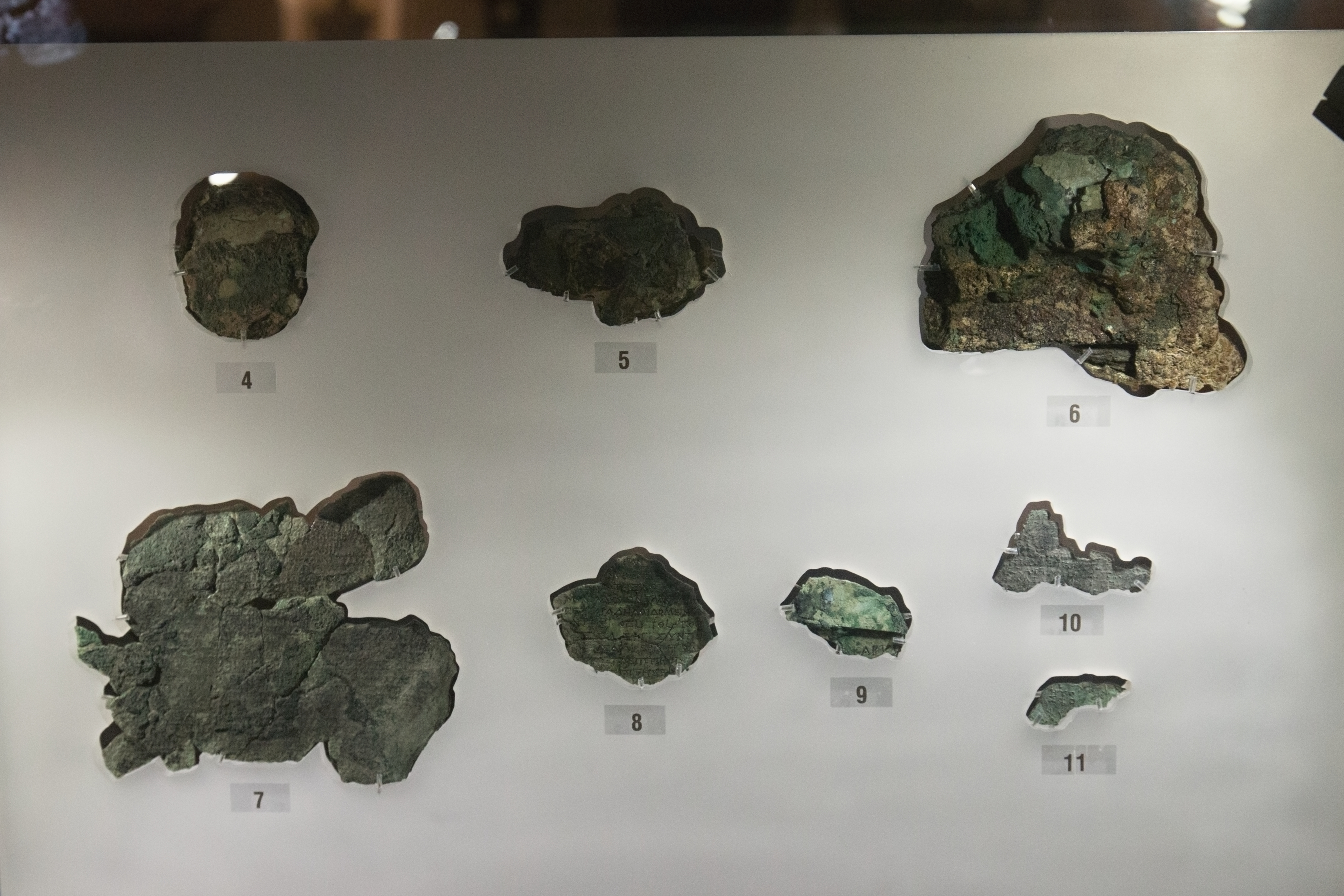 Close view of a major corroded bronze Antikythera mechanism fragment showing gear traces.