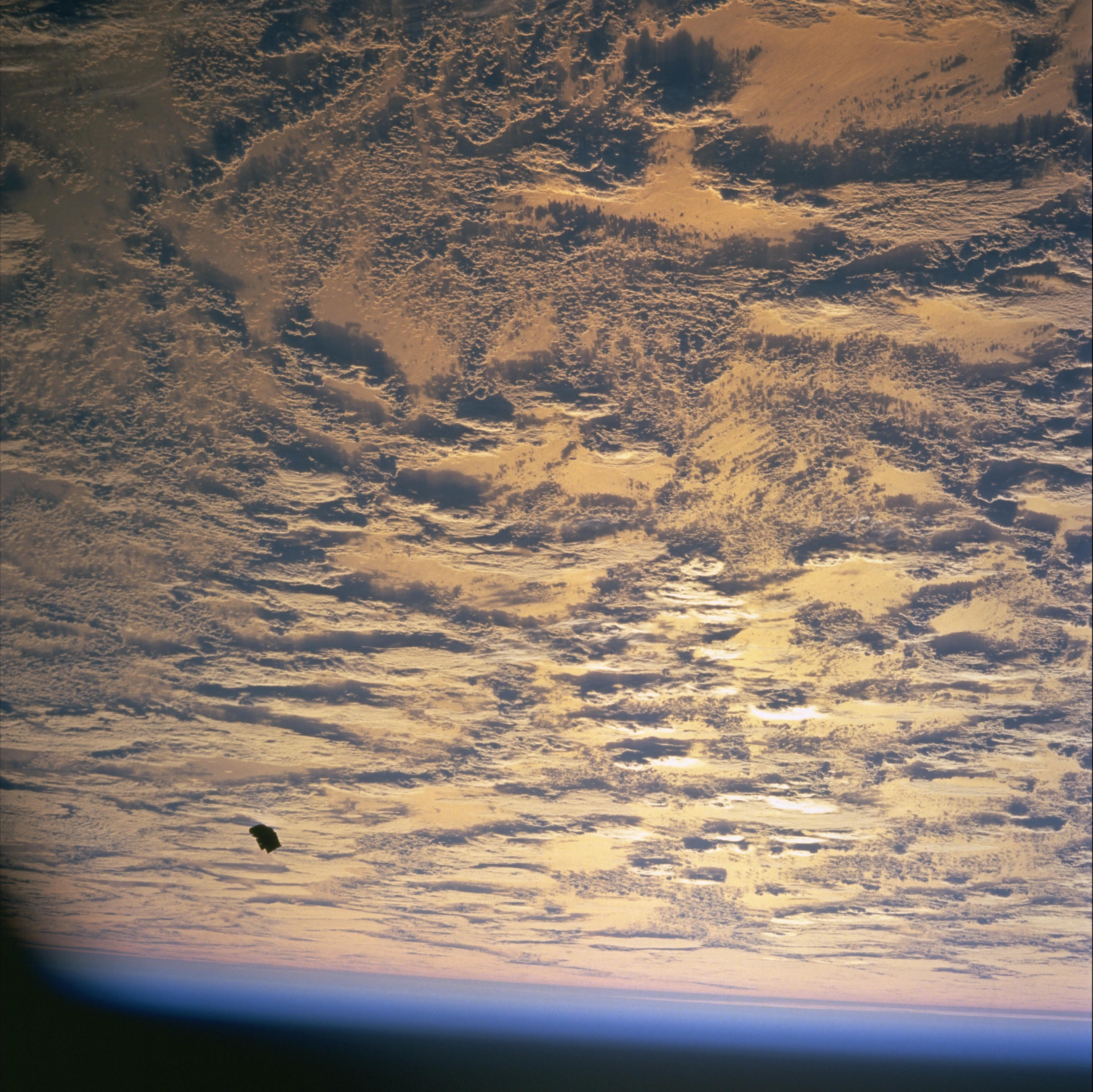 Another STS-88 cabin still of the same tumbling thermal-cover debris against Earth, NASA PD.
