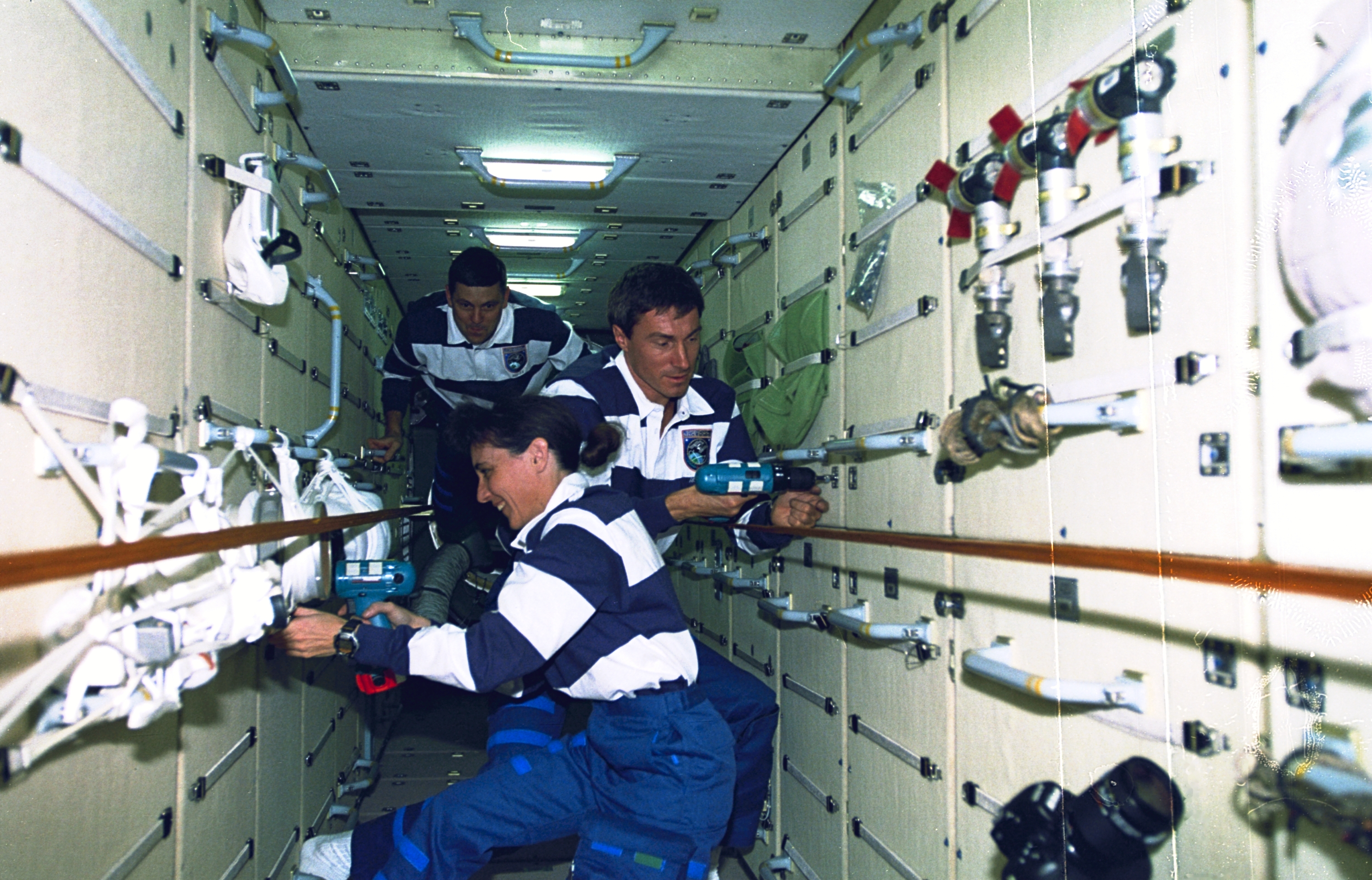 STS-88 crew working on the early ISS stack during station assembly - mission context for the EVA debris, NASA public domain.
